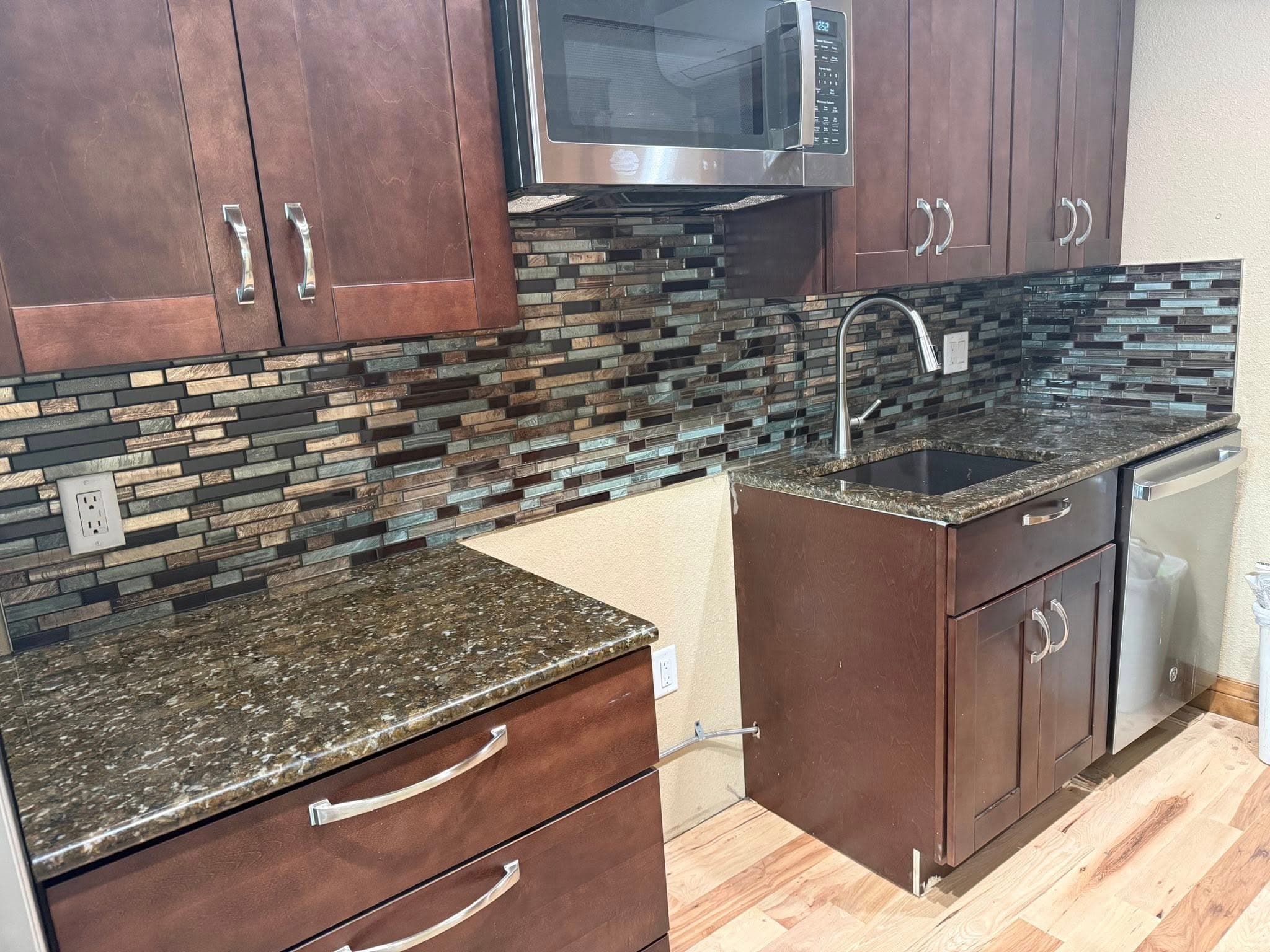 Kitchen with linear glass mosaic backsplash