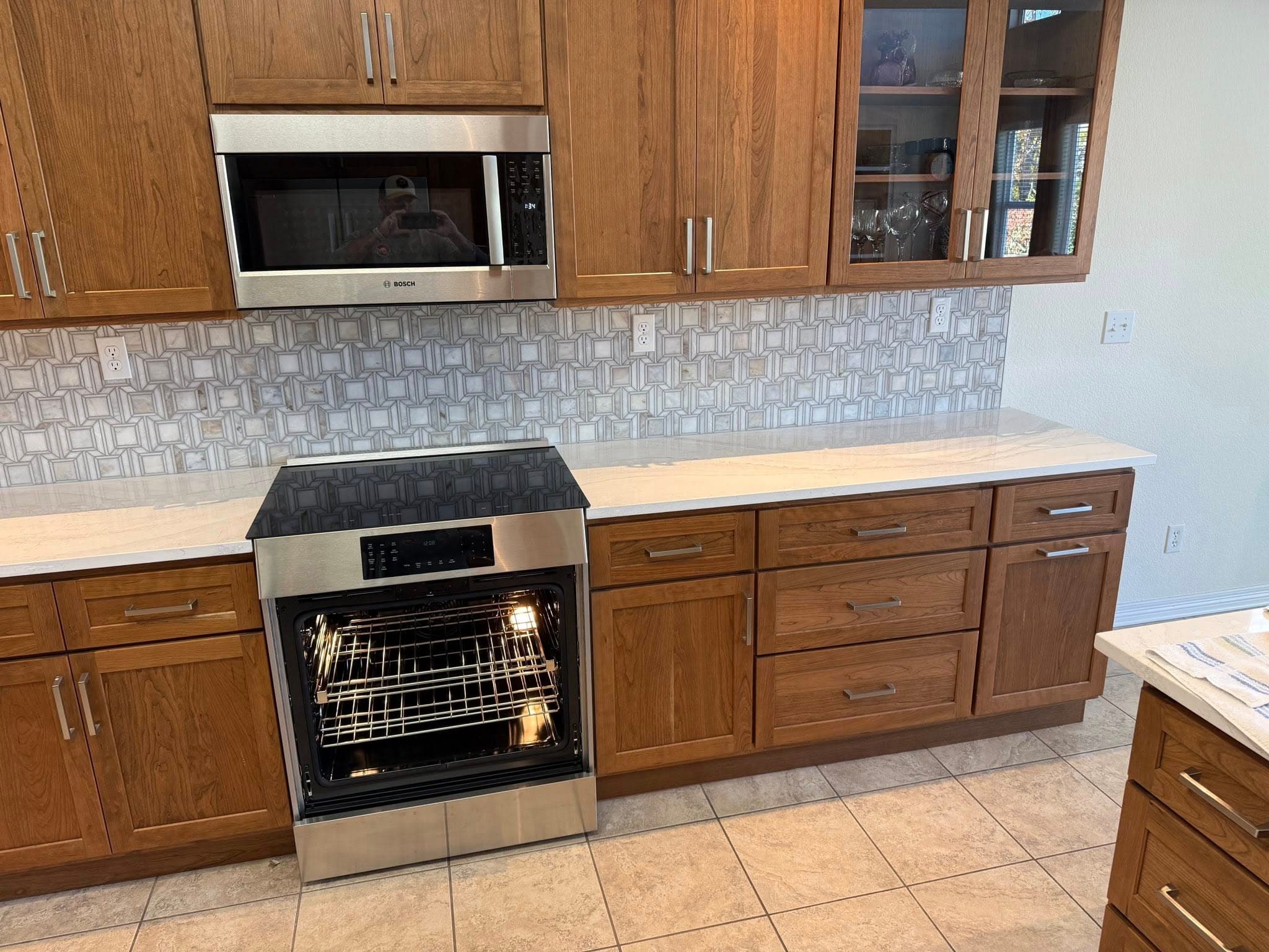 Warm wood kitchen with patterned mosaic backsplash